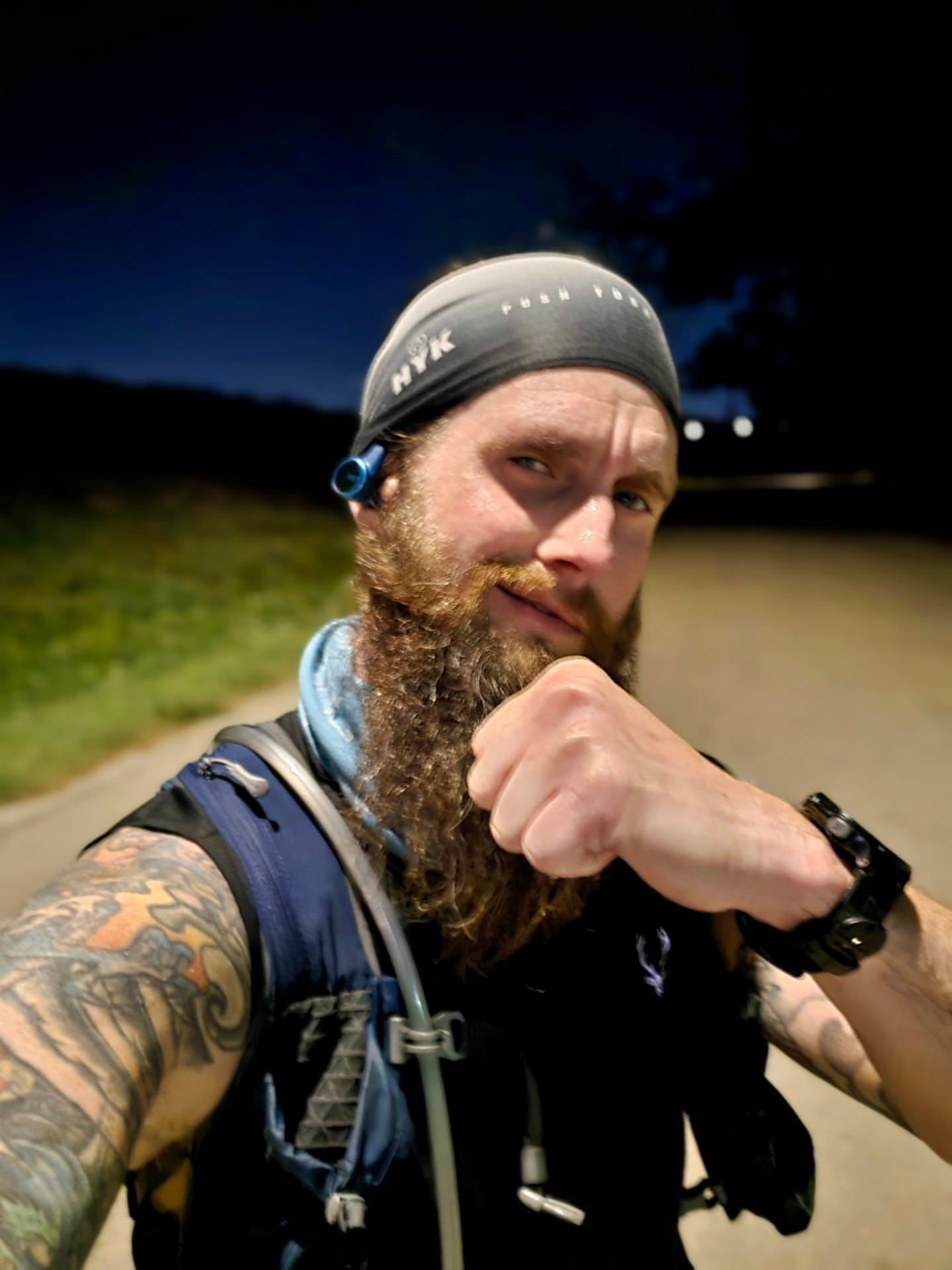 Man running and drinking HYK electrolytes to rehydrate.